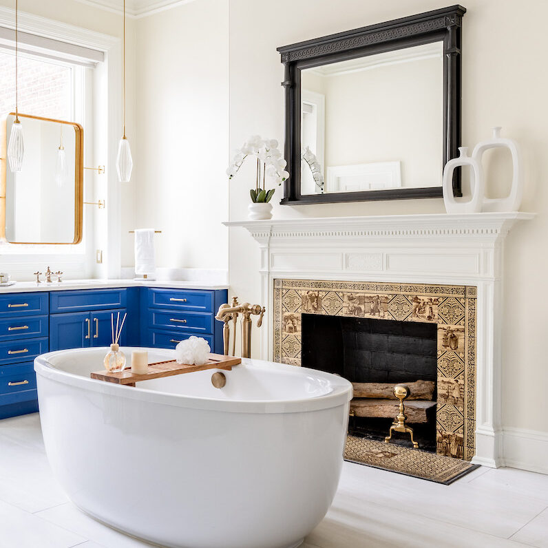 A modern bathroom with vibrant blue cabinets and a sleek white tub, offering a clean and refreshing look.