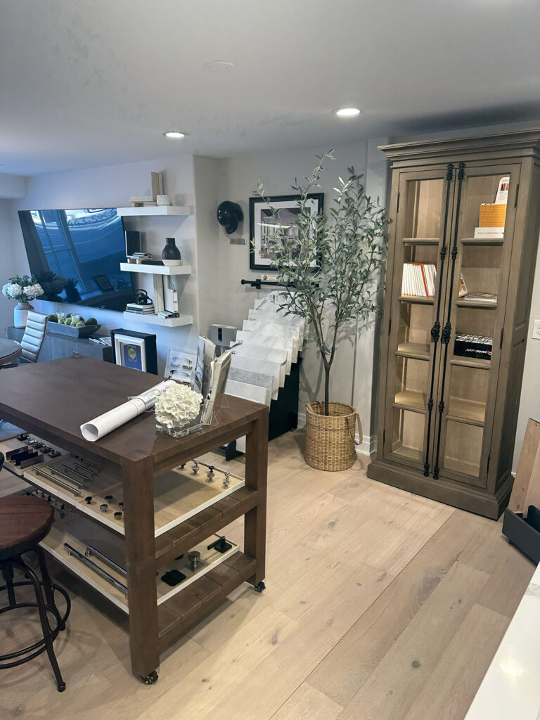 A modern office space and meeting area for an architect or contracting business featuring natural wood and recessed lighting.