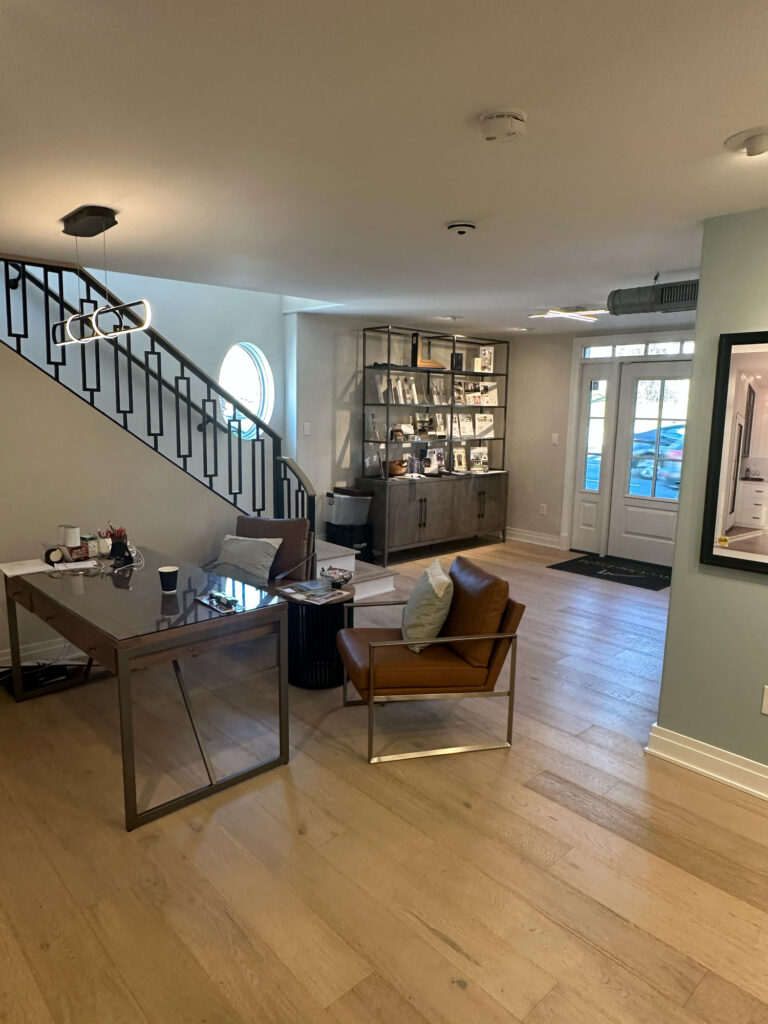 Inside Five One Eight Contracting's modern feeling business. There are touches or brushed metal and glass alongside natural wood floors and muted walls.