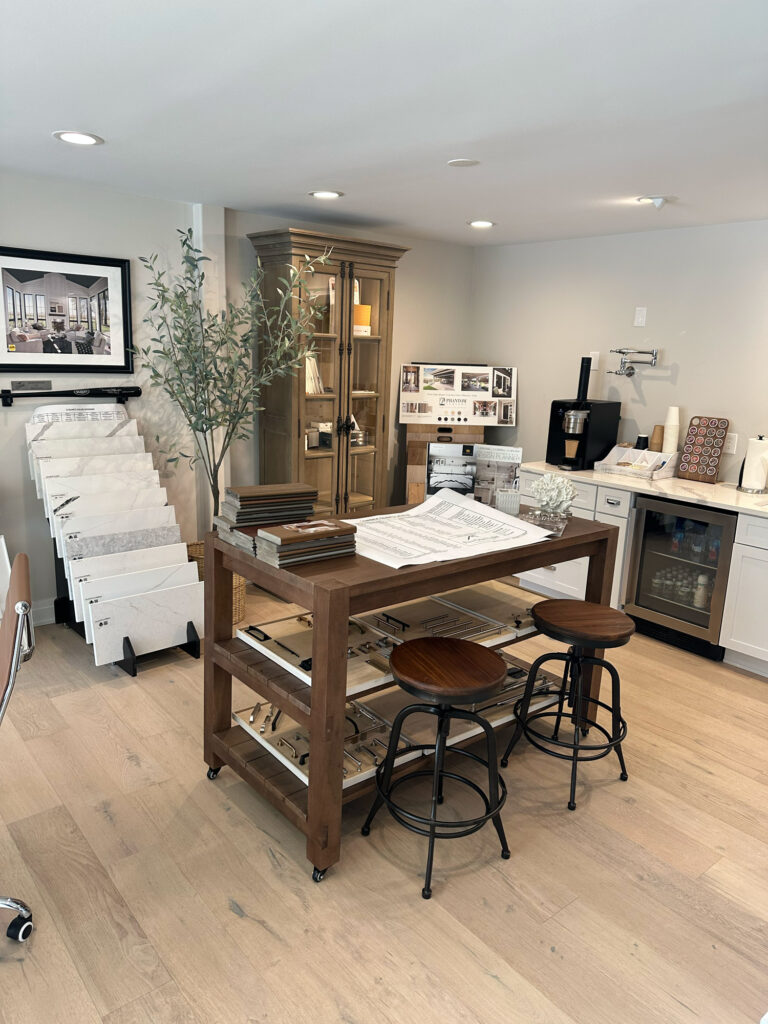 A modern office space and meeting area for an architect or contracting business featuring natural wood and recessed lighting.