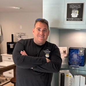 Close-up of Matt Solel smiling with his arms crossed over his chest